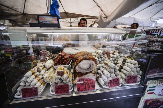 CANCER-CAUSING, SAYS W.H.O. A picture shows traditional 'porchetta' and sausages on a delicatessen stall at the Campo di Fiori food market, in central Rome, on November 4, 2014. Andreas Solaro/AFP 