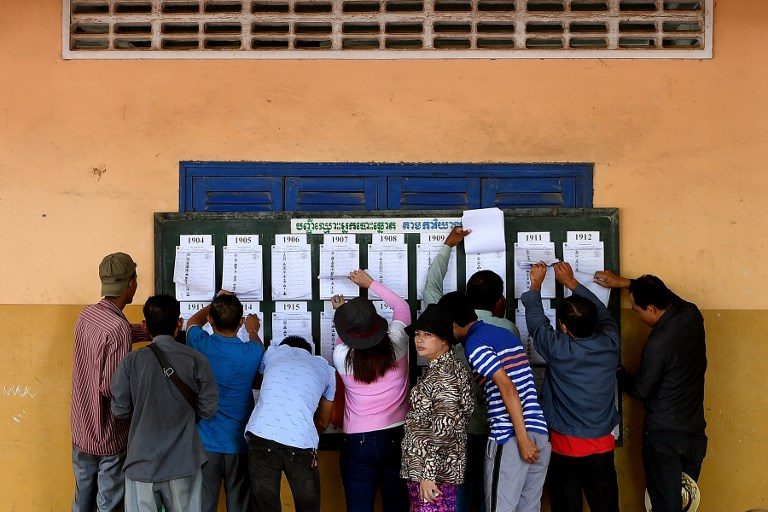 ELECTION DAY. Cambodians check their names on a voters list at a polling station in Phnom Penh on July 29, 2018. Photo by Manan Vatsyayana  