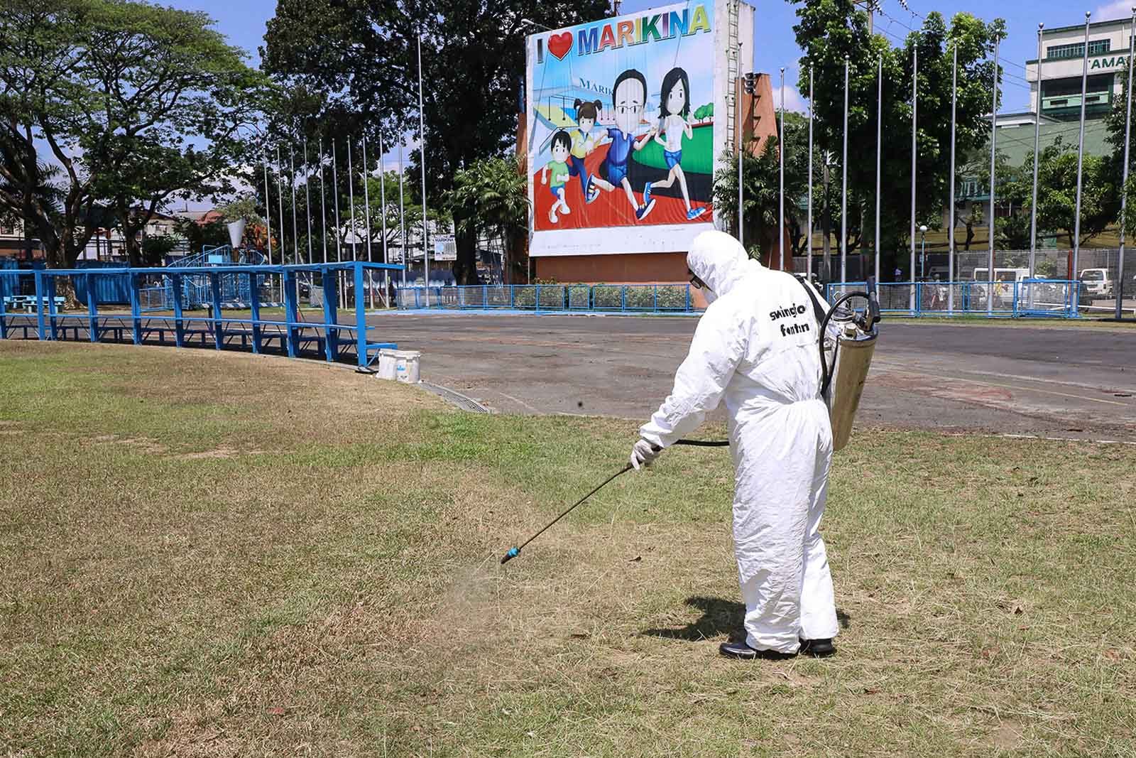 FRONTLINES. A health worker disinfects Marikina Sport Center on Monday, March 9, 2020. File photo by Darren Langit/Rappler 