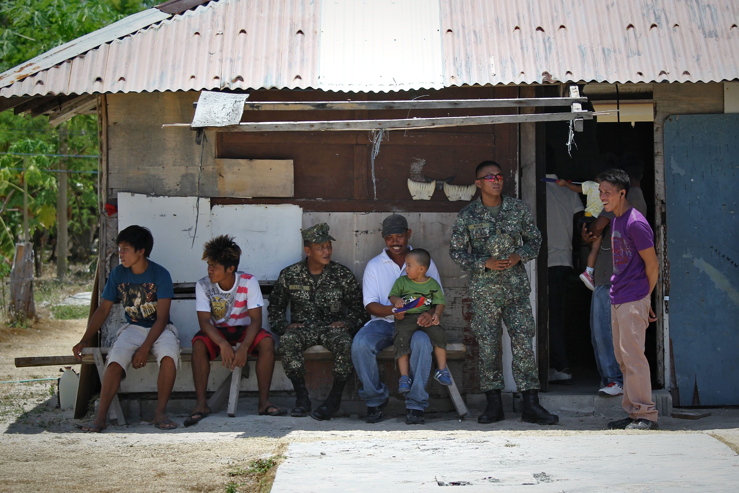 JUST ANOTHER DAY. Soldiers and civilians on Pag-asa Island. Photo by Vincent Go/Rappler 