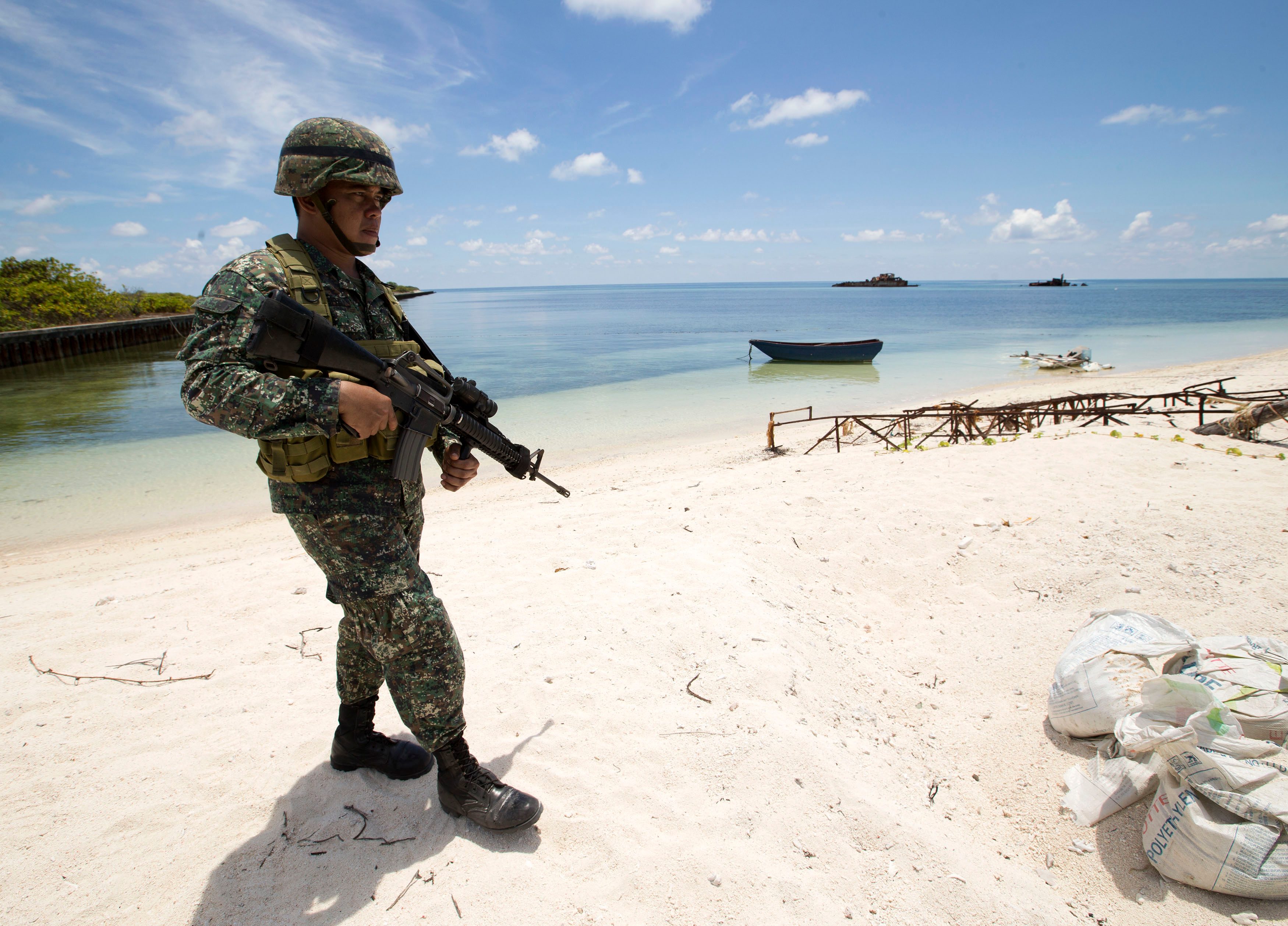 MARINE. Filipino soldier Tychico Octobre patrols on the shores of Pagasa (Thitu) island  in the Spratlys. Photo by Ritchie Tongo/EPA      