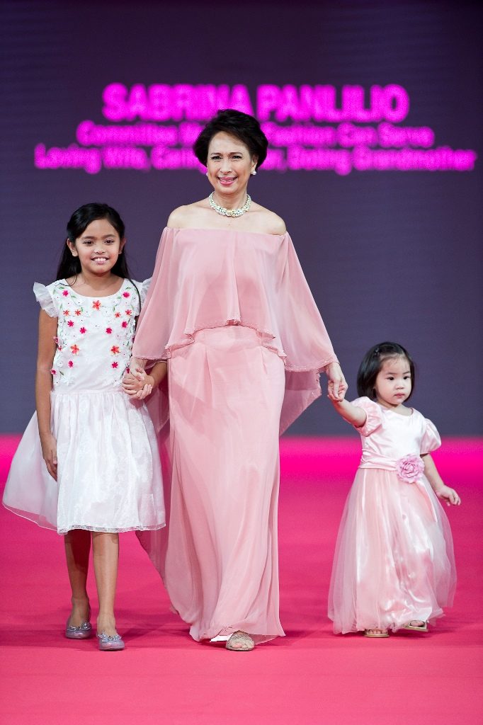 Sabrina Panlilio, a Fashion Can Serve committee member and a 15-year breast cancer survivor, wearing Mia Arcenas, with grandchildren Sophia and Zoya in Rustan's collection.  
