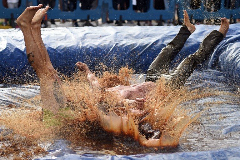 GRAVY WRESTLING. Competitors wrestle in a pool of Lancashire gravy during the 10th annual World Gravy Wrestling Championships held at the Rose 'n' Bowl Pub in Bacup, England, on August 28, 2017. Photo by Oli Scarff/AFP  