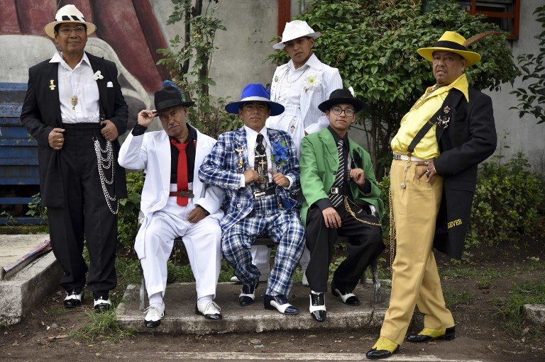 MAMBO KINGS. A group of 'Pachucos' pose for a picture at the Cultural Poliforum Carranza square in Mexico City on August 27, 2017. Photo by Yuri Cortez/AFP  