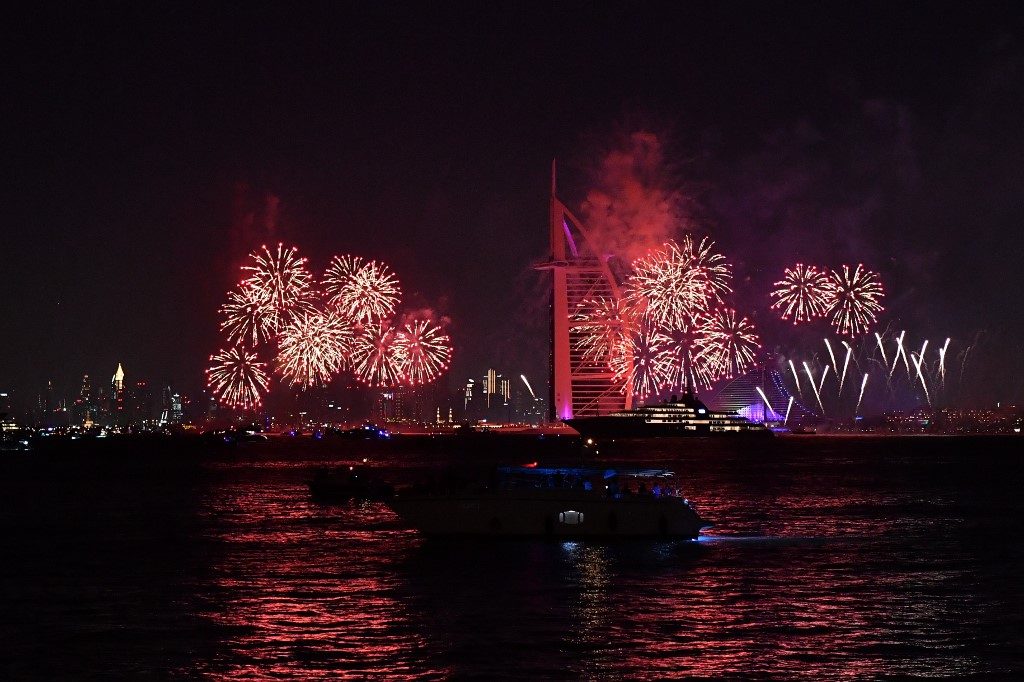 DUBAI. New Year's fireworks celebrations are seen above the Dubai skyline with the Burj Al Arab (R) and Burj Khalifa(L), the world's tallest building, on December 31, 2019. Photo by Giuseppe Cacace/AFP  