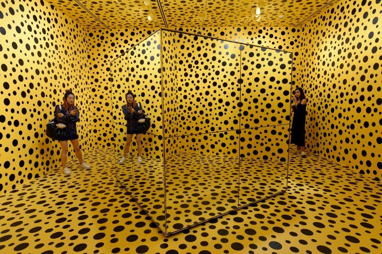 JAPANESE ART. Visitors stand inside an installation by Japanese artist Yayoi Kusuma titled, 'The Spirits of the Pumpkins Descended into the Heaven' during a media preview at the National Gallery Singapore on June 6, 2017. Photo by Roslan Rahman/AFP   