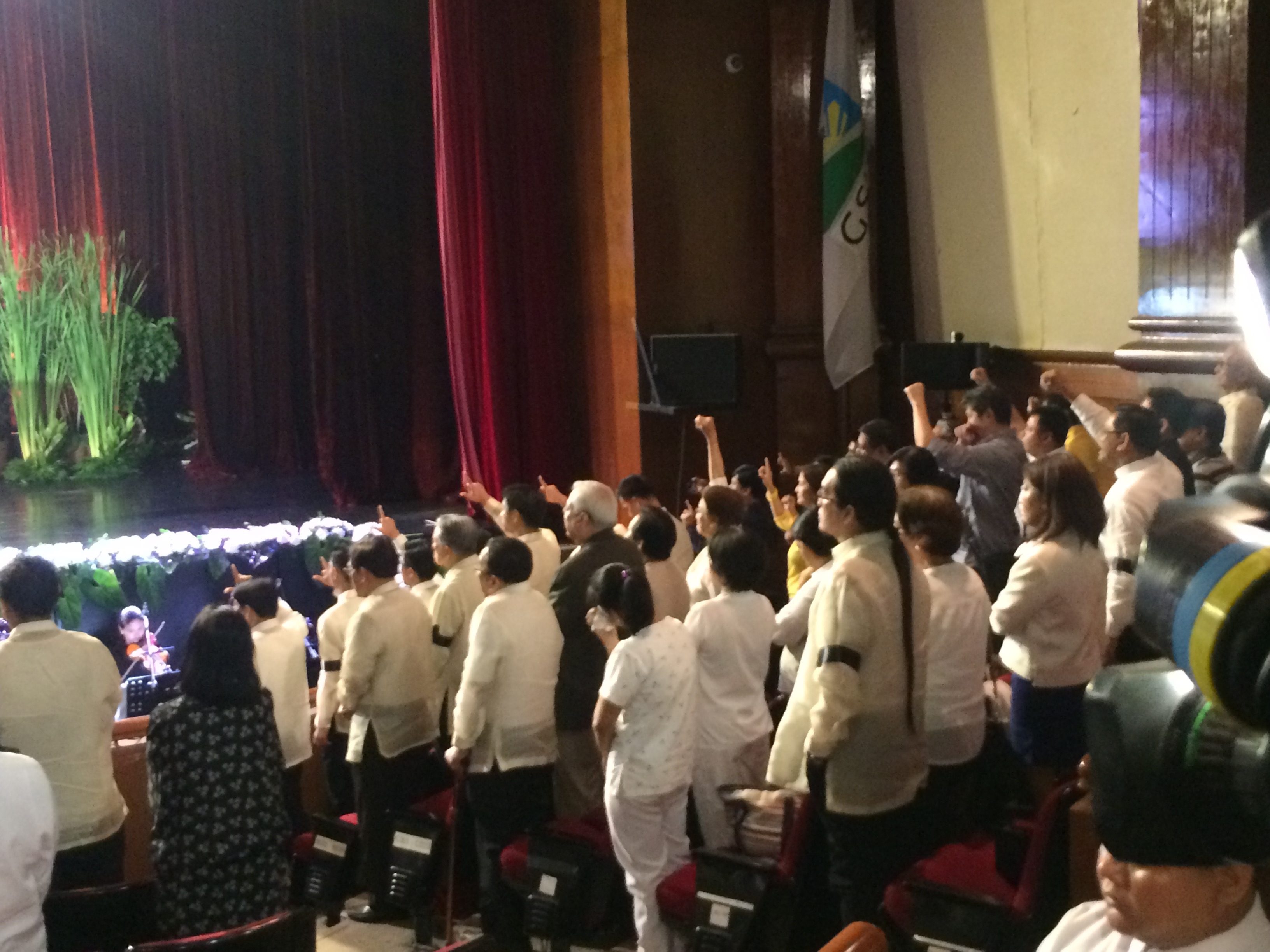 'BAYAN KO.' Members of the audience, including sitting LP officials and members, raise their fists and flash the 'Laban' sign during necrological services for the late Jovito Salonga. Photo by Bea Cupin/Rappler
  