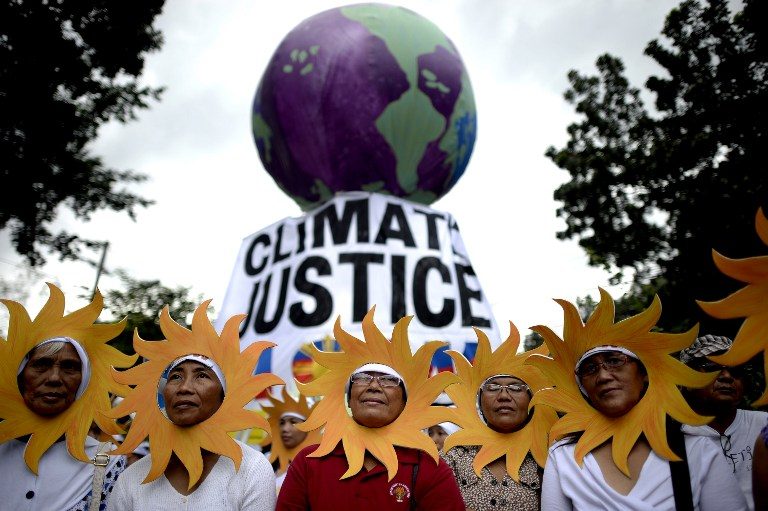 CLIMATE JUSTICE. Protesters attend a climate change march on a highway in Manila on November 28, 2015.  Noel Celis/AFP   