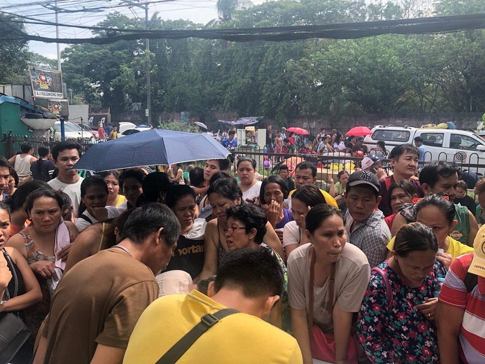 DISPLACED. Residents gather on the roadside as firemen put out te blaze in their community on June 27, 2019. Photo from Mandaue City PIO Facebook page 