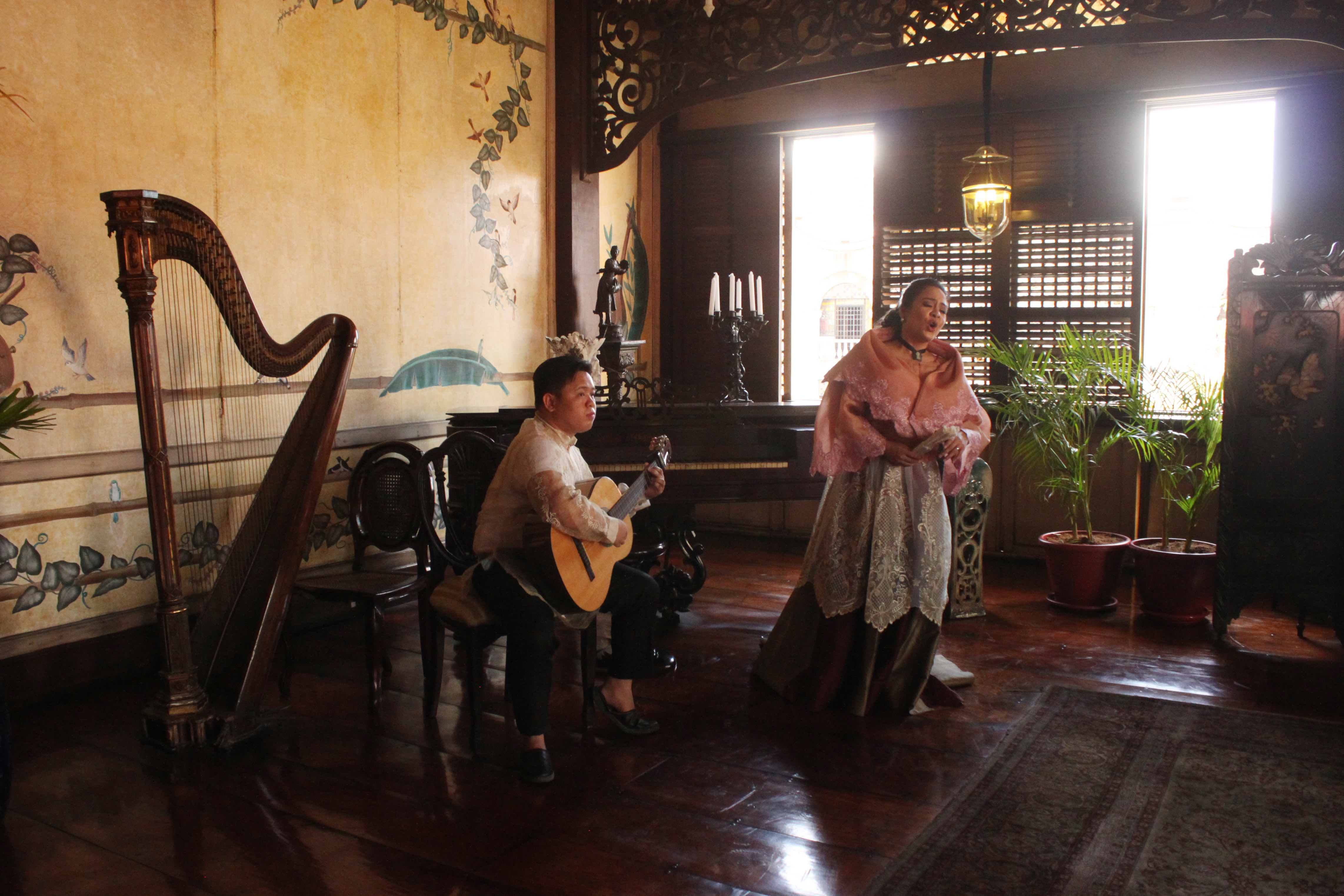 MORE SONGS. Performers in traditional Filipino wear serenade the spouses.