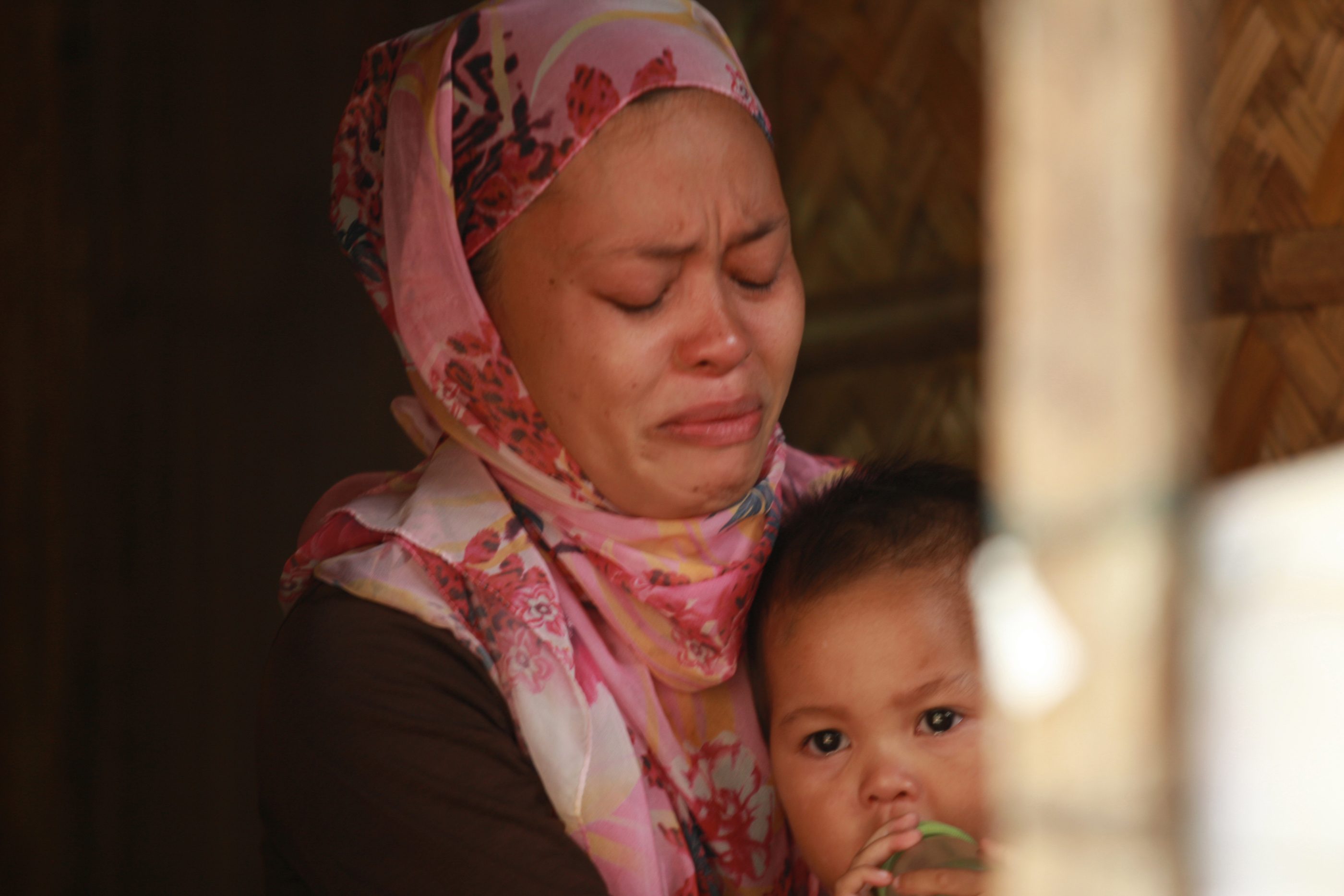 STILL GRIEVING. Fatima Sandigan, 39, cries as she remembers her last moments with her husband, Mamarizah. He was one of the MILF fighters who died on January 25, 2015, leaving behind Fatima and their 3 children. 