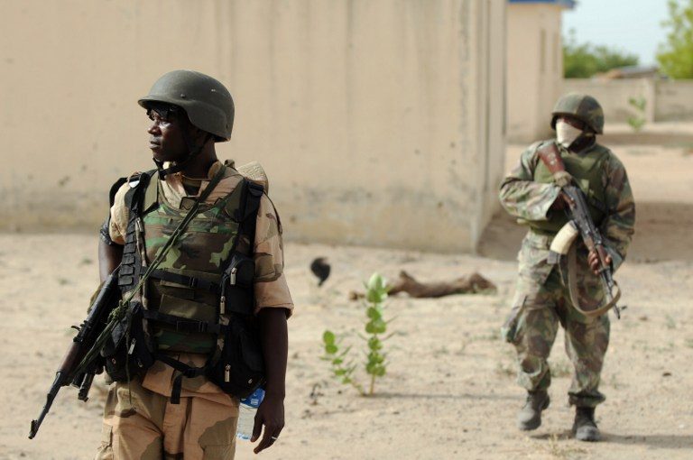 LOOKOUT. A file photo taken on June 5, 2013 shows Nigerian soldiers patrolling in the north of Borno state close to a Islamist extremist group Boko Haram former camp near Maiduguri. Quentin Leboucher/AFP  