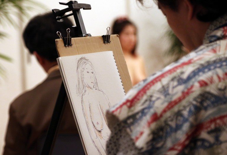 EXPLORATION. This picture taken on April 26, 2015 shows people including middle aged men sketching a nude model at a studio in Tokyo. Yoshikazu Tsuno/AFP 