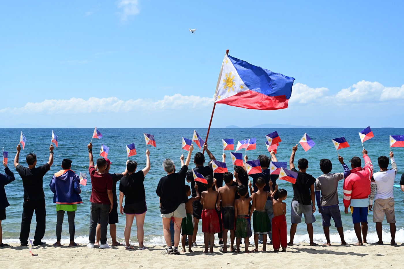 LOOK: Otso Diretso supporters raise PH flags to oppose Chinese vessel in Batangas