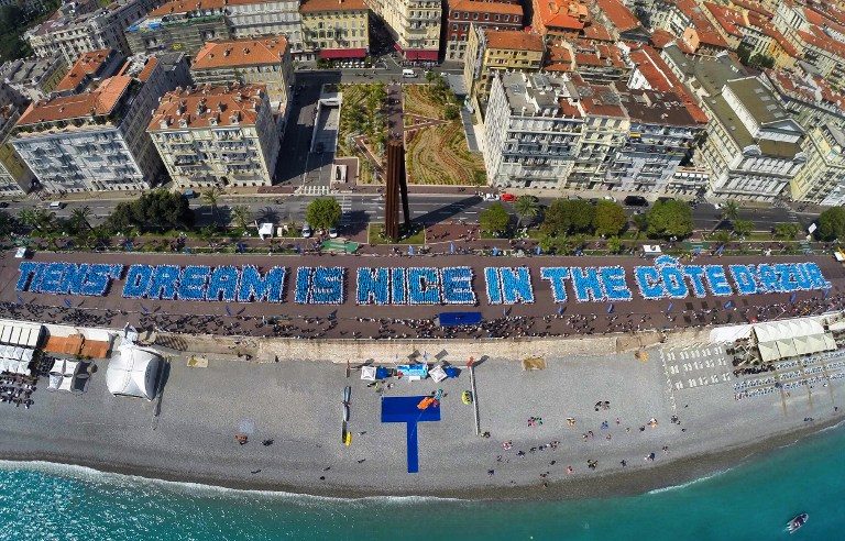 RECORD-BREAKING. This handout aerial picture taken and released by Image Trans on May 8, 2015 in Nice, southern France, shows employees of Chinese company 'Tiens' arranging themselves on the Promenade des Anglais in the French southern resort town to spell out the phrase 'Tiens' dream is Nice in the Cote d'Azur.' Image Trans/Handout/AFP 