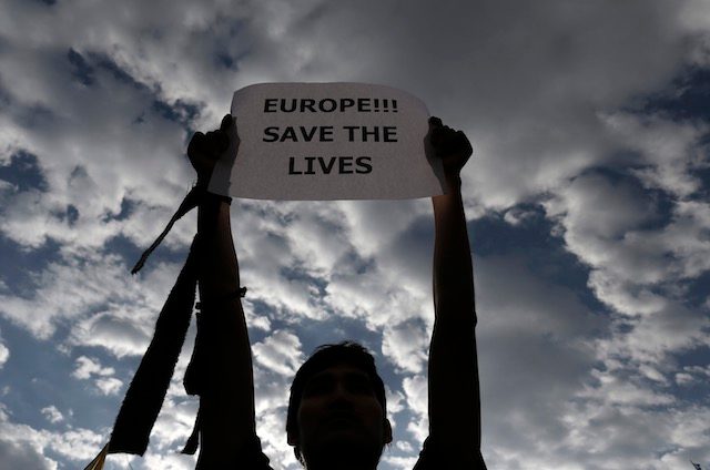 'SAVE THE LIVES' An immigrant living in Greece takes part in a protest against the deaths of migrants in the Mediterranean, outside the European Union office in central Athens, Greece, April 22, 2015. Yannis Kolesidis/EPA 