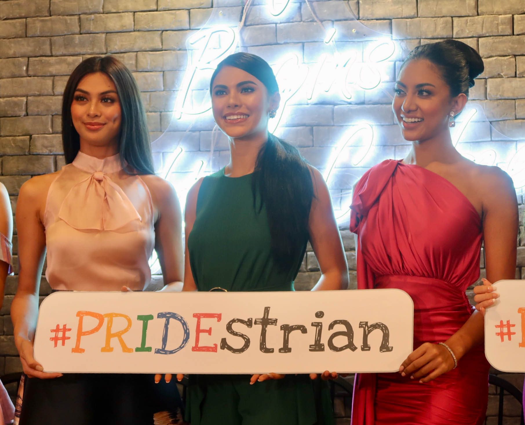 PRIDESTRIAN. Bb. Pilipinas International 2019 Patch Magtanong, Miss Universe Philippines 2019 Gazini Ganados, and Bb Pilipinas Supranational 2019 Resham Saeed hold the 'Pridestrian' sign. 