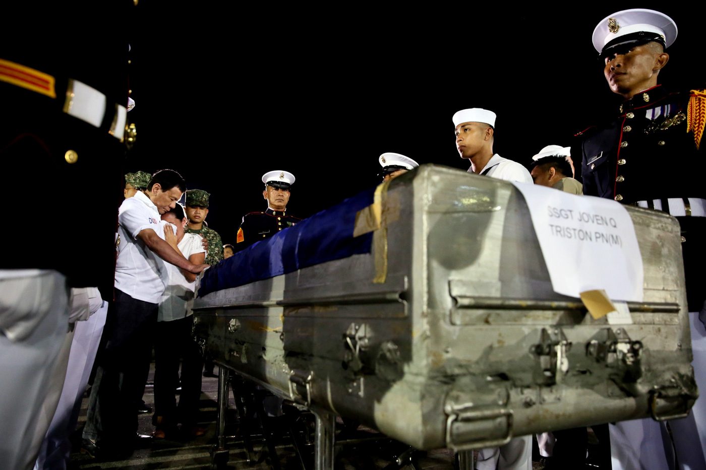 SYMPATHY. President Rodrigo Duterte condoles with bereaved families as he honors the Philippine Marines killed in anti-terror operations in Marawi City during the transfer of the soldiers' remains in Villamor Air Base in Pasay City on June 11, 2017. Malacañang Photo   
