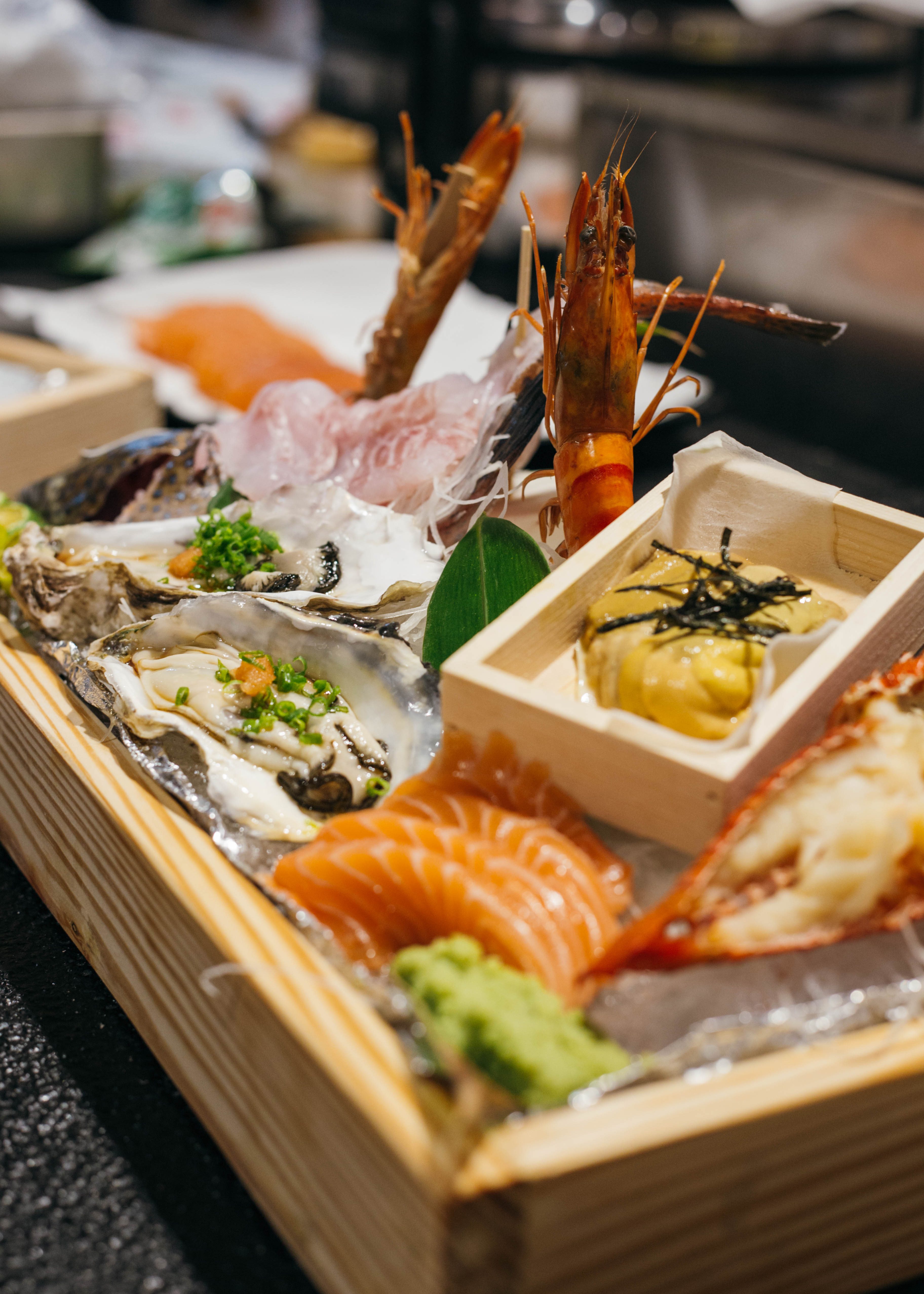 A platter of assorted seafood made upon request: lobster, salmon, uni (sea urchin), oyster, prawns, and groupers 