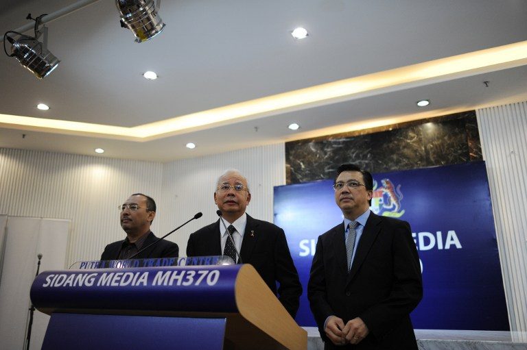 BEARER OF NEWS. Malaysia's Prime Minister Najib Razak (C) delivers a statement on the missing Malaysia Airlines flight MH370 days after the discovery of a washed-up plane part on the French Indian Ocean island of La Reunion during a press conference in Kuala Lumpur early on August 6, 2015. Mohd Rasfan/AFP 