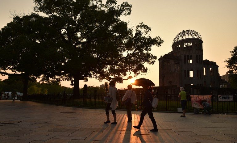 SURVIVOR. People walk past the Atomic Bomb Dome beside the Peace Memorial Park at sunset in Hiroshima on August 5, 2015. Kazuhiro Nogi/AFP 