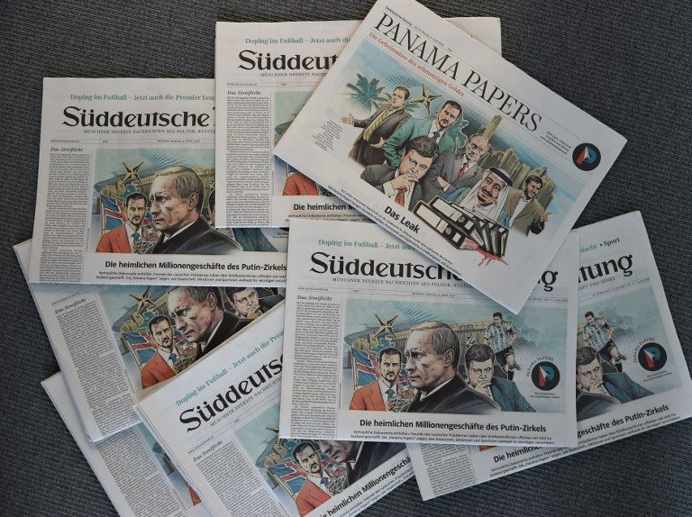 A photo taken on April 7, 2016 in Munich, southern Germany, at the office of the German daily 'Sueddeutsche Zeitung' shows several issues of the newspaper dated April 4, 2016, titling on the so-called "Panama Papers" with illustrations by German artist Peter M Hoffmann depicting heads of state. Christof Stache/AFP  