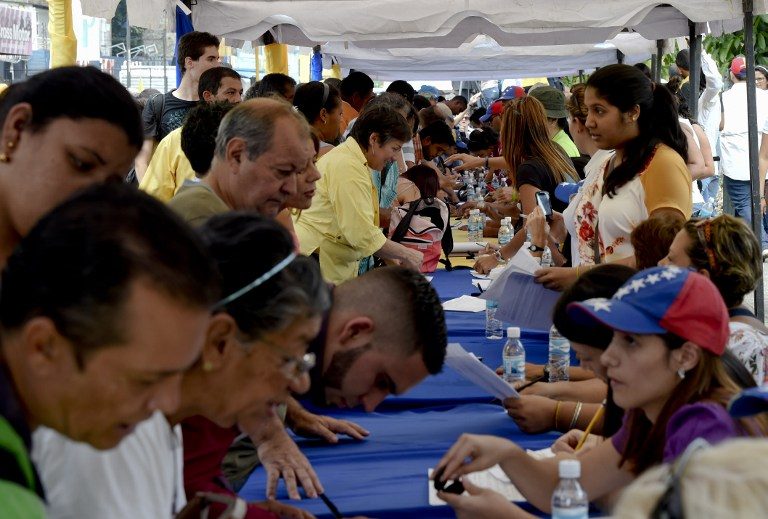 Sick of crisis, Venezuelans line up to recall Maduro