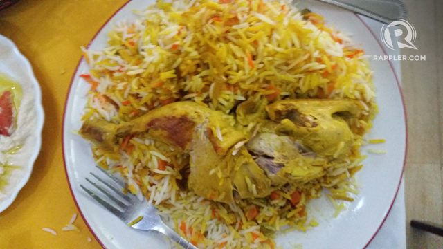 BIRYANI. A mound of aromatic basmati rice with a piece of seasoned chicken