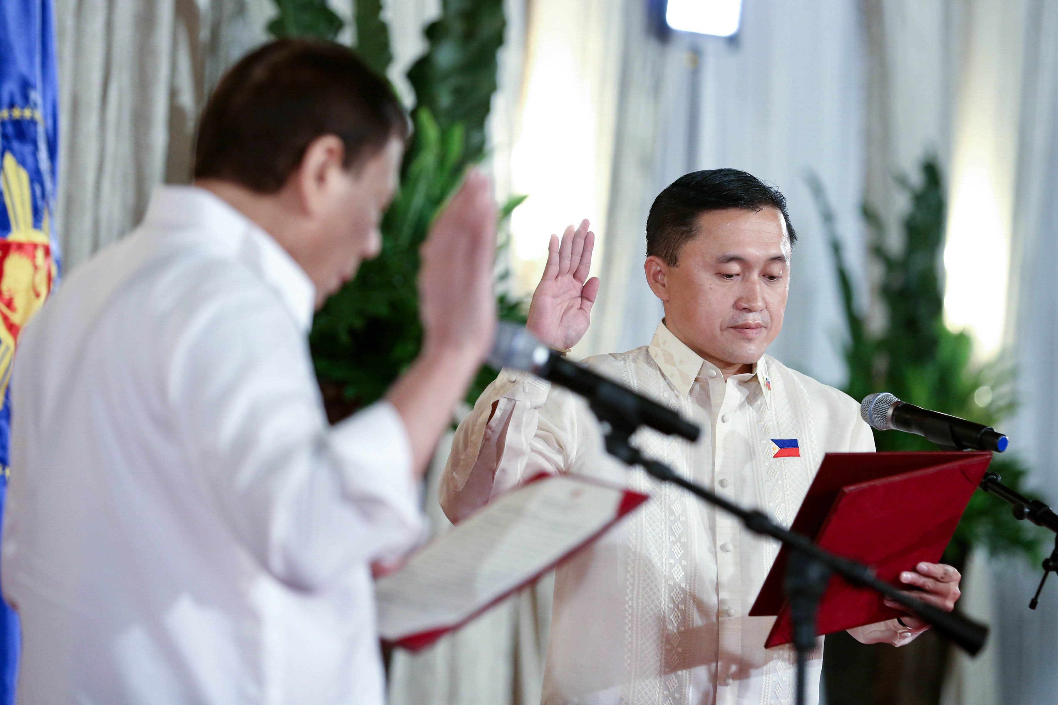 BOSS AND AIDE. President Rodrigo Duterte administers the oath to senator-elect Bong Go. Malacañang photo  