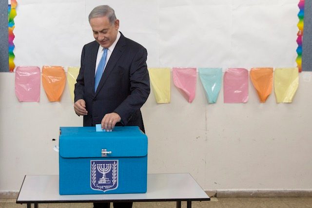 FOURTH TERM COMING? Israeli Prime Minister Benjamin Netanyahu casts his vote for the Israeli general elections at a polling station in Jerusalem, 17 March 2015. Sebastian Scheiner/Pool/EPA 