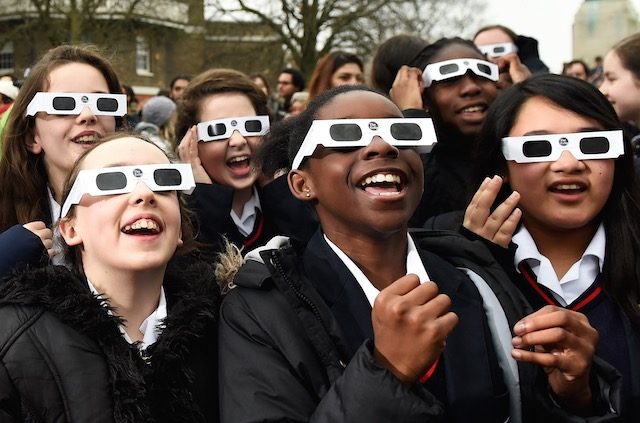 AWED. Students from St. Ursula's convent pose with refractive glasses on the Meridian line at The Royal Observatory in Greenwich, south east London, Britain, March 20, 2015. Facundo Arrizabalaga/EPA 