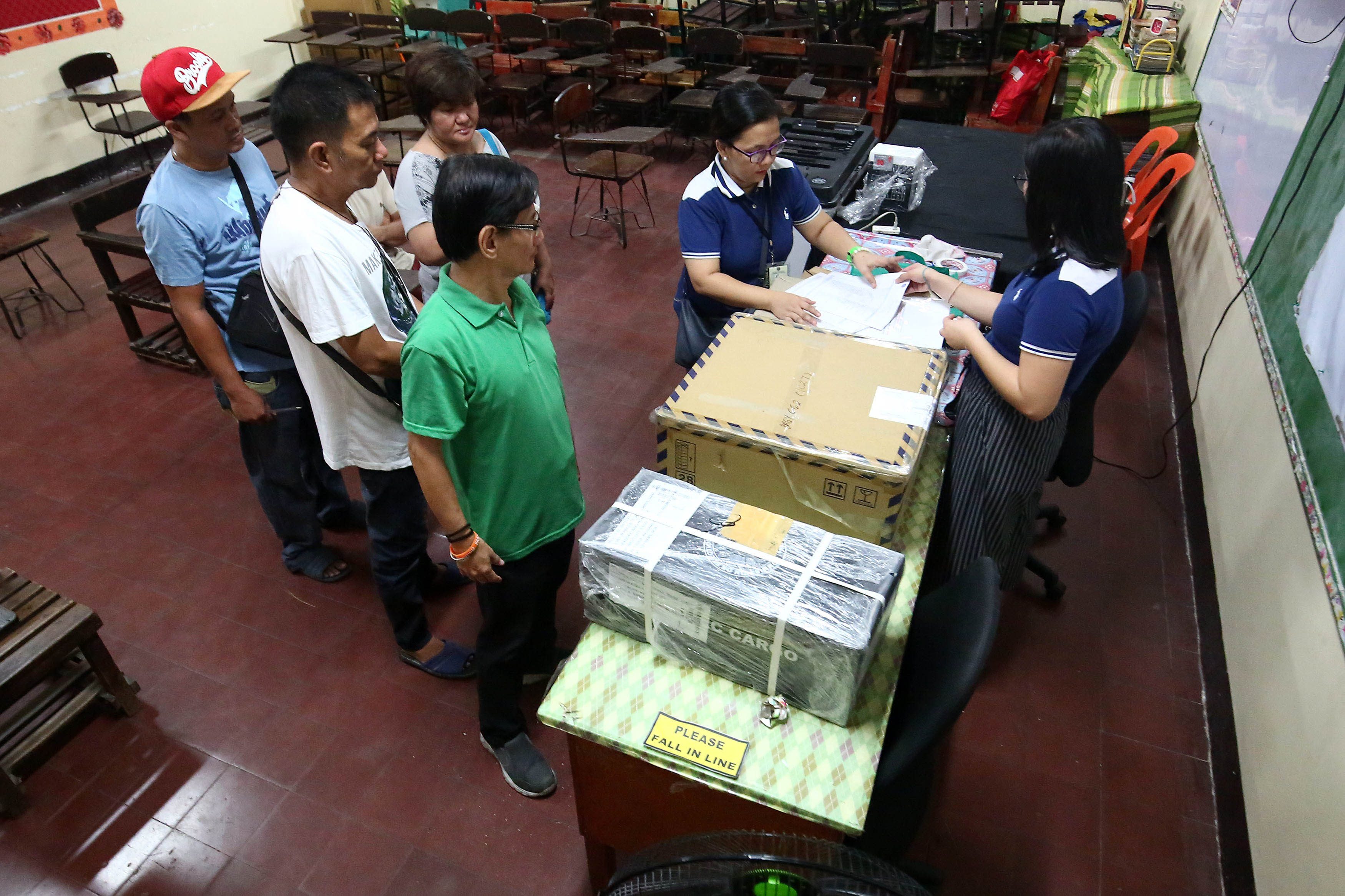MANILA. Teachers and poll watchers await the arrival of voters as they prepare the election paraphernalia at the Araullo High School in Manila on Monday, May13. Photo by Ben Nabong/Rappler 
