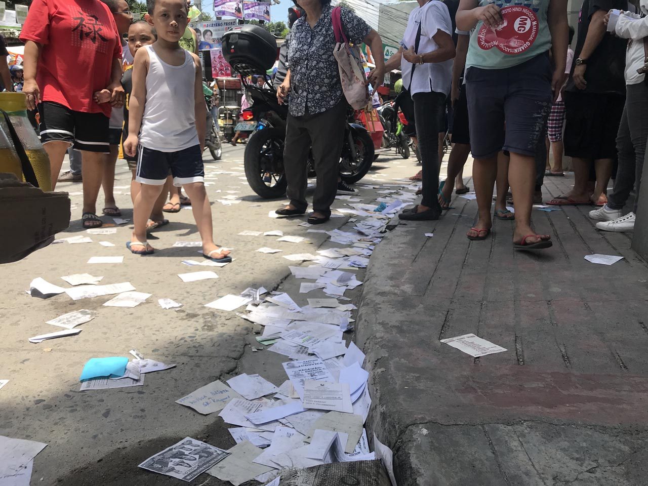 ILLEGAL. Campaign paraphernalia and sample ballots litter just outside a polling precinct in Barangay Payatas, Quezon City. Photo by Rambo Talabong/Rappler 