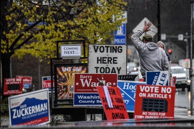 AMERICA VOTES. Campaign signs for various candidates are seen outside the Montpelier Town Hall on November 6, 2018, in Vermont. Photo by Stephanie Keith/Getty Images/AFP  