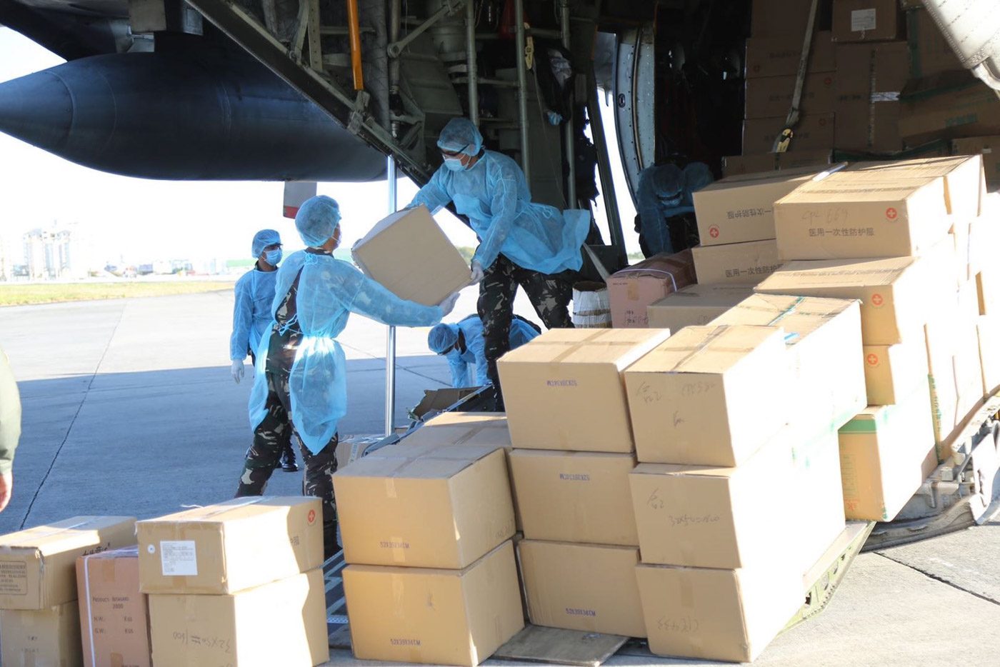 EQUIPMENT, SUPPLIES. Soldiers unload donated cargo from the Philippine Air Force's C-130 plane at Villamor Airbase on March 21, 2020. Photo from the Armed Forces of the Philippines 