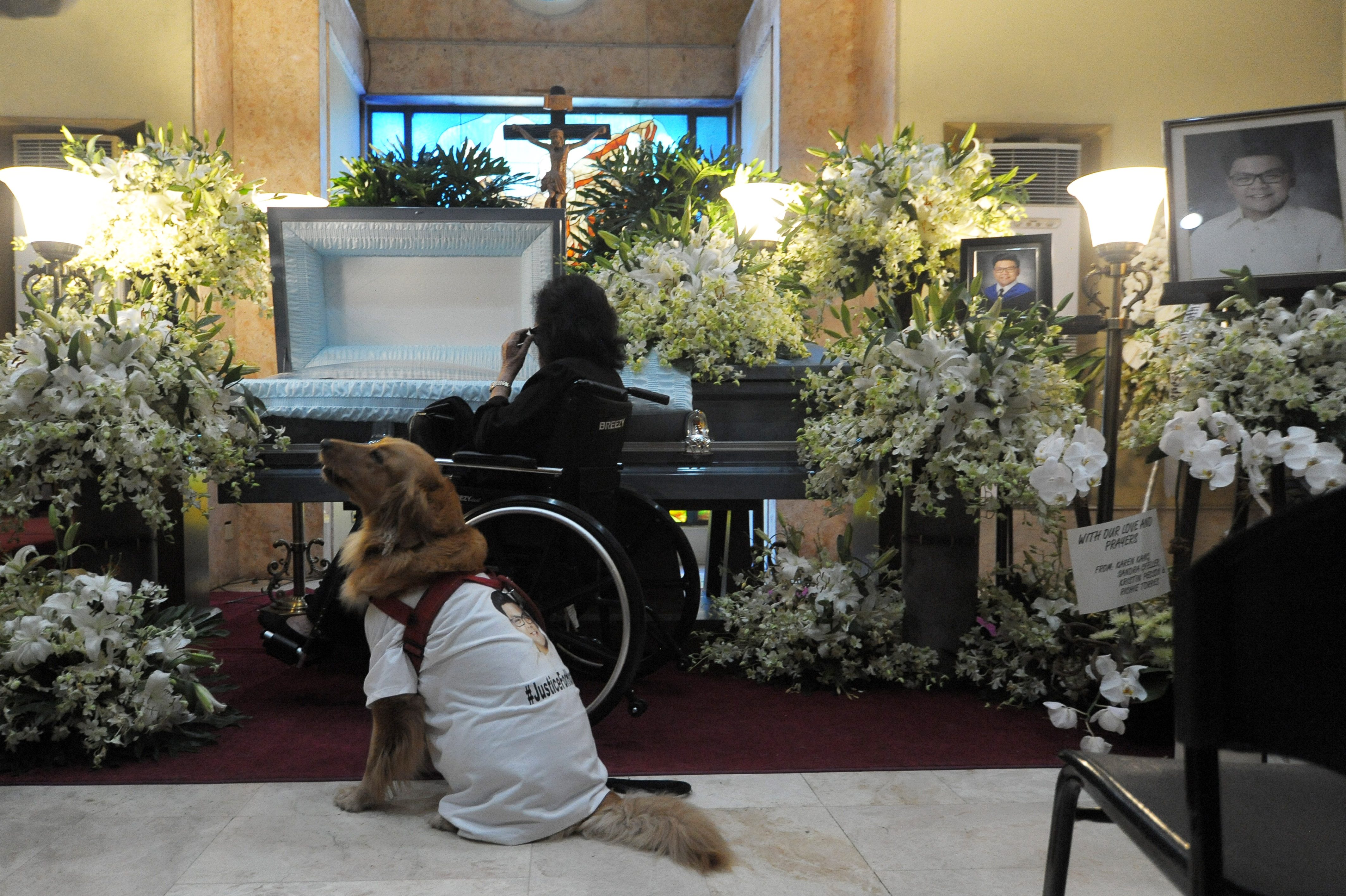 LEGA. Wearing a "#JusticeForHoracio" shirt, Horacio Castillo's dog, Lega, pays her final respects to her master during a funeral mass on September 27, 2017. Photo by Ben Nabong/Rappler  