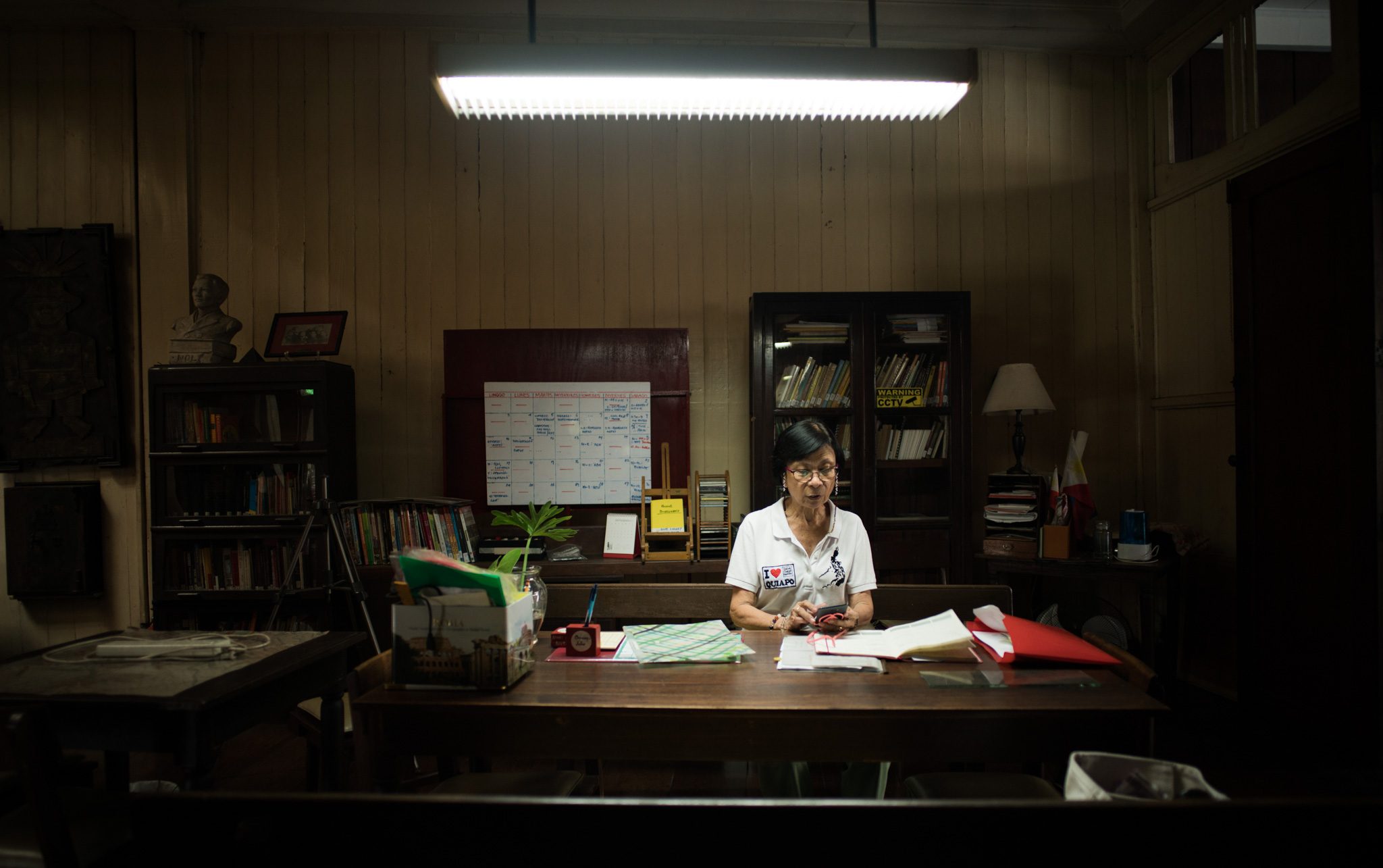 Bobby Nakpil Santos-Viola works from her makeshift office in one of the house's rooms. Her efforts, as well as that of a handful of volunteers, are keeping the house alive. Photo by Martin San Diego/Rappler 
