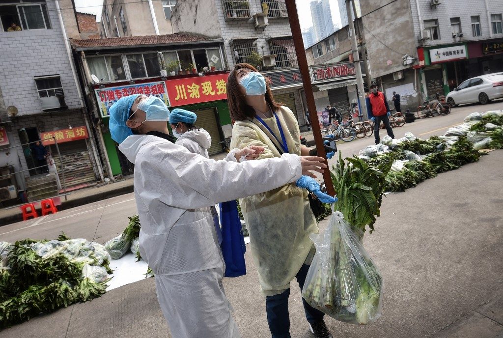 China virus epicenter to open up as world locks down