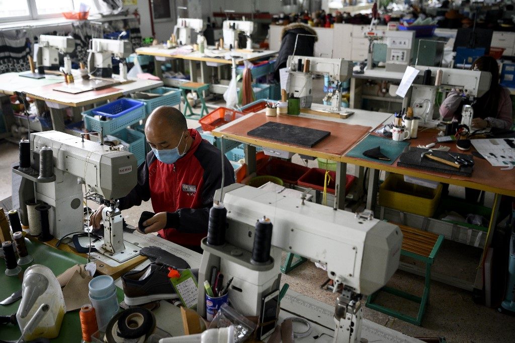 One worker at a time, virus-hit China’s factories sputter back online