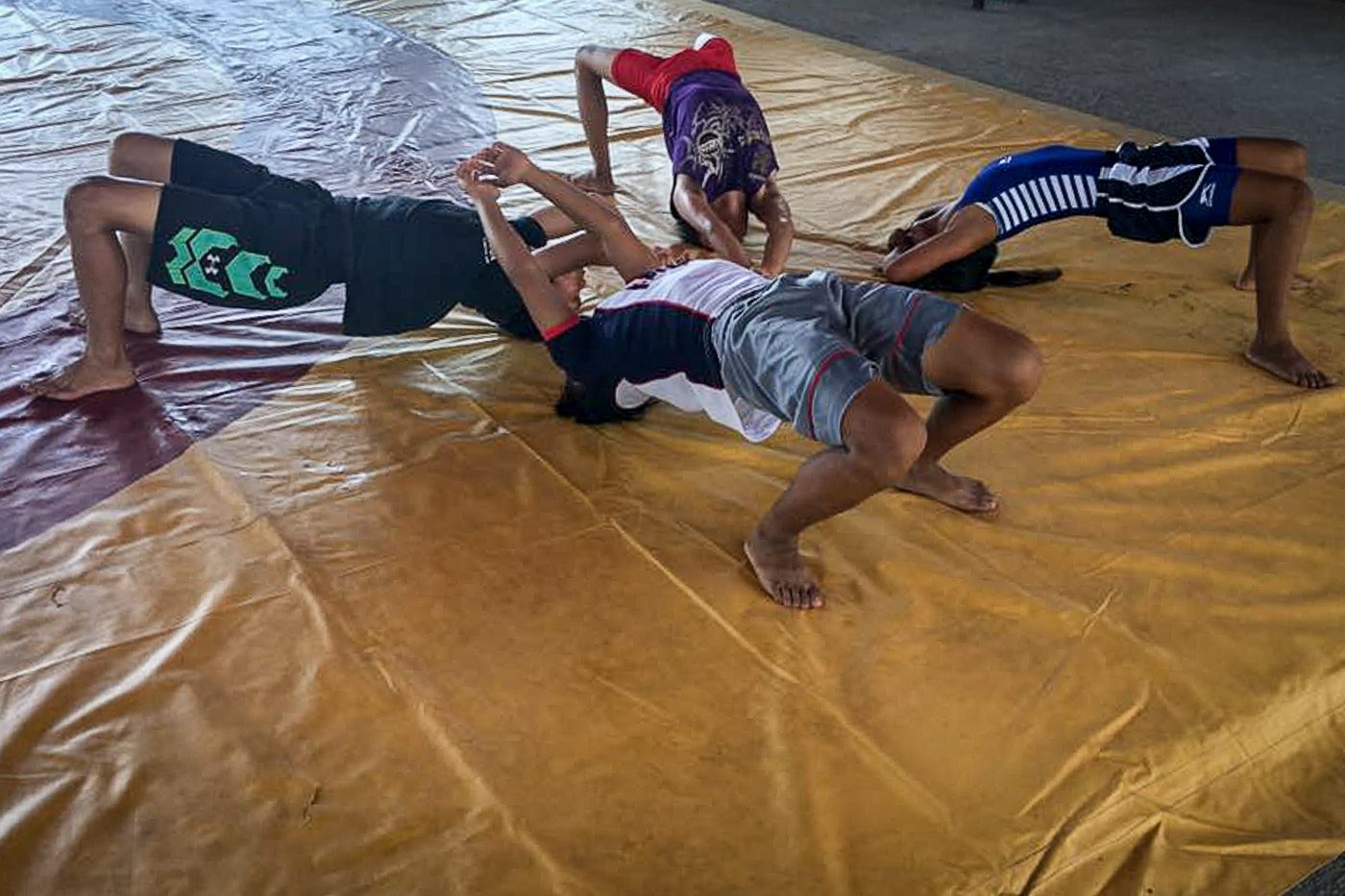 WARM UP. CLRAA athletes prepare for their wrestling match at Hamtic Central School Gymnasium. Photo by Regine Villafuerte/ Rappler
  