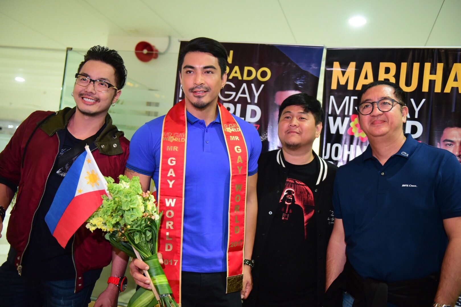 John with the Mr Gay World Philippines organization upon their arrival in NAIA 1. Photo by Alecs Ongca/Rappler  