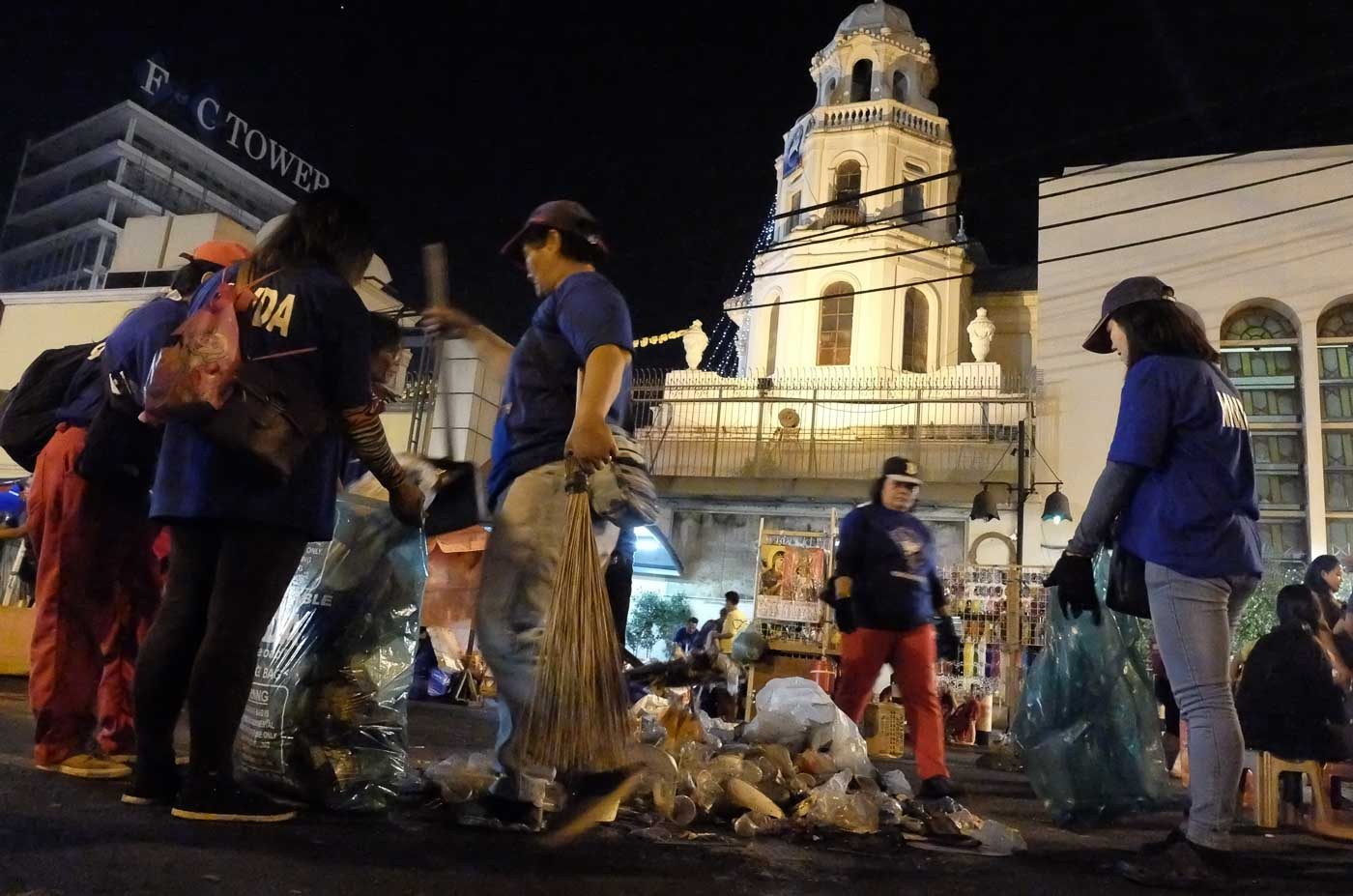 BASURA PATROLLERS. A combined team from the Manila City Hall DPS and the MMDA cleans up the vicinity of Plaza Miranda and Quiapo Church in Manila at the end of the Traslacion. Photo by Alecs Ongcal/Rappler  