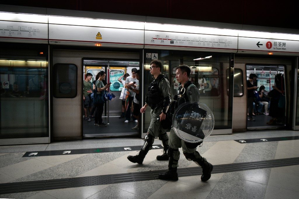 CHECKING FOR PROTESTERS. Police check for protesters as they patrol on the platform of the Lai King MTR underground train station in Hong Kong on September 2, 2019. Photo by Anthony Wallace/AFP 