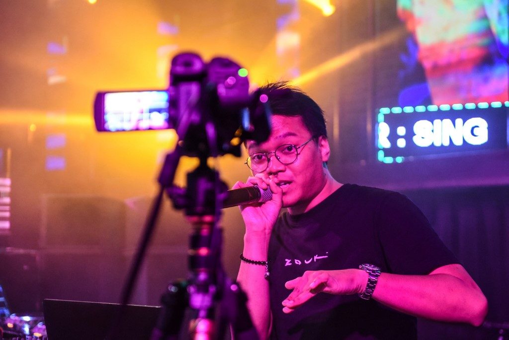 RECORDING. This photo taken on March 27, 2020 shows the nightclub Zouk's DJ Mr J performing in front of a video camera during a "cloud-clubbing" party that was live-streamed following the temporary closure of entertainment venues in Singapore. Photo by Catherine Lai / AFP 