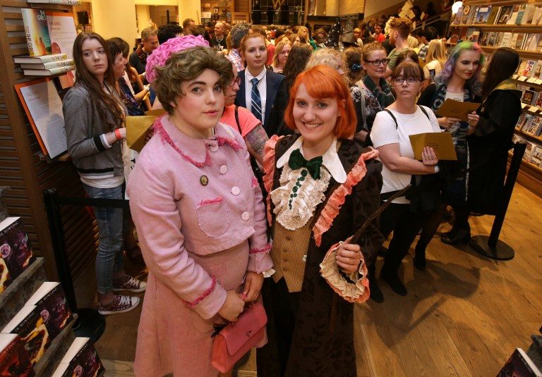 Harry Potter fans, Fran Plagge (R) and Lottie (L) will be first and second to receive the new Harry Potter script book inside Waterstones bookshop on Piccadilly in central London on July 30, 2016, during the midnight party celebrating the launch. Photo by Daniel Leal-Olivas / AFP 