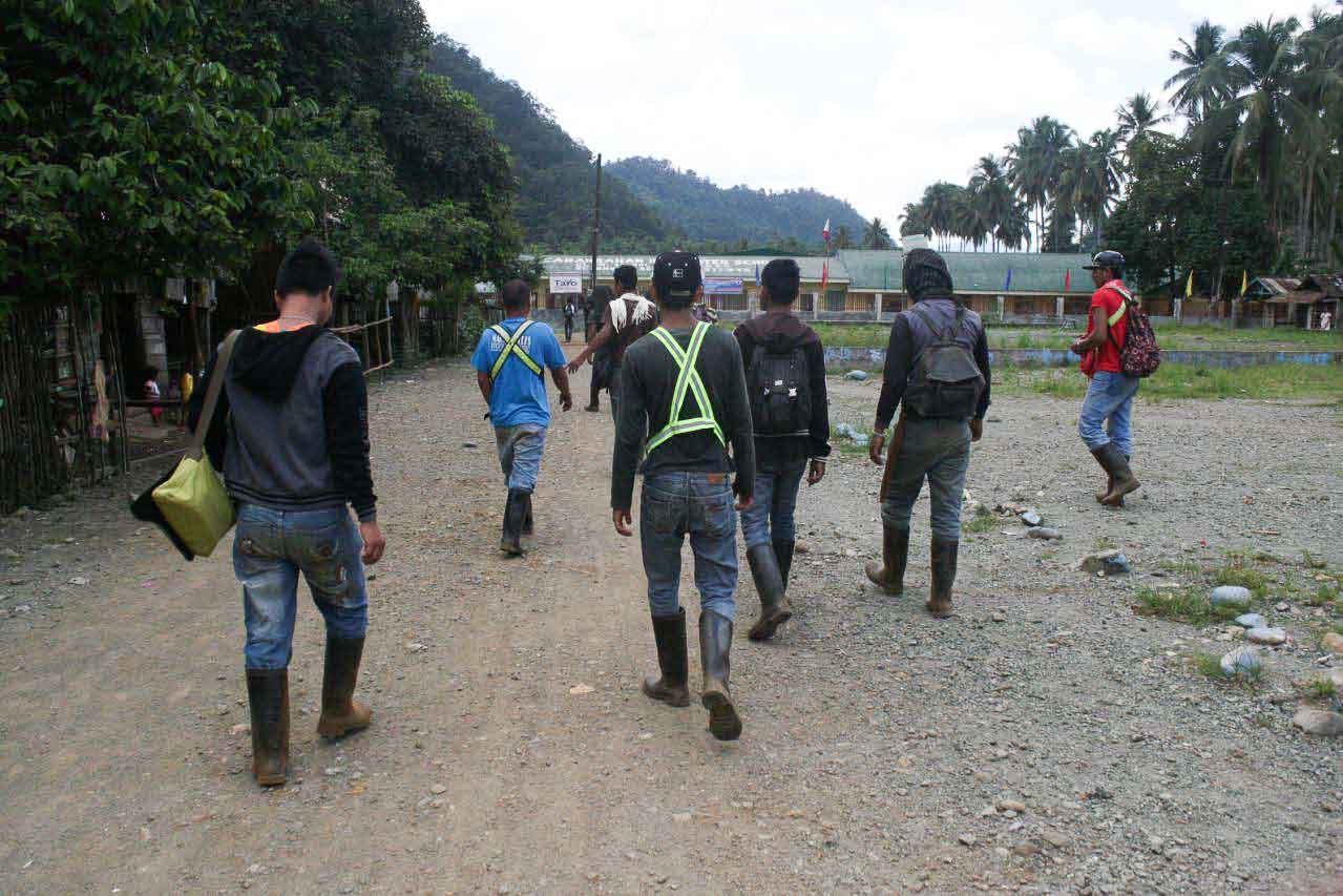 MINING WORKERS. Members of the Manobo tribe who work for Marcventures Mining and Development Corp walk to work in the middle of this town. Photo by Alex Baluyut