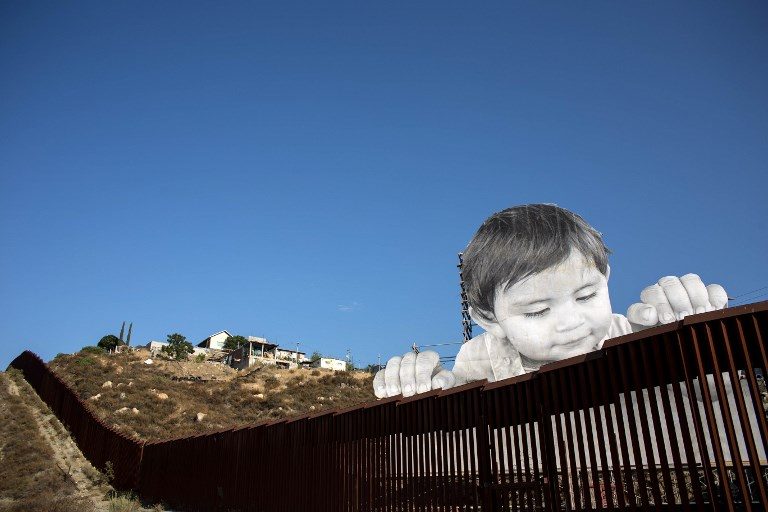 BORDER ART. An artwork by French artist JR on the US-Mexico border in Tecate, California, United States, on September 6, 2017. Photo by Guillermo Arias/AFP 
