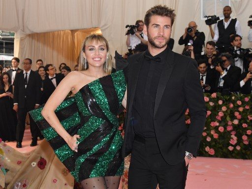 Miley Cyrus (R) and Liam Hemsworth arrive for the 2019 Met Gala at the Metropolitan Museum of Art on May 6, 2019, in New York. Photo by Angela Weiss/AFP 