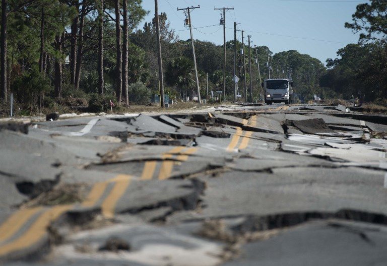 AFTER THE STORM. A truck stops while surveying the road destroyed during Hurricane Michael near Eastpoint, Florida, on October 12, 2018. Photo by Andrew Caballero-Reynolds/AFP  