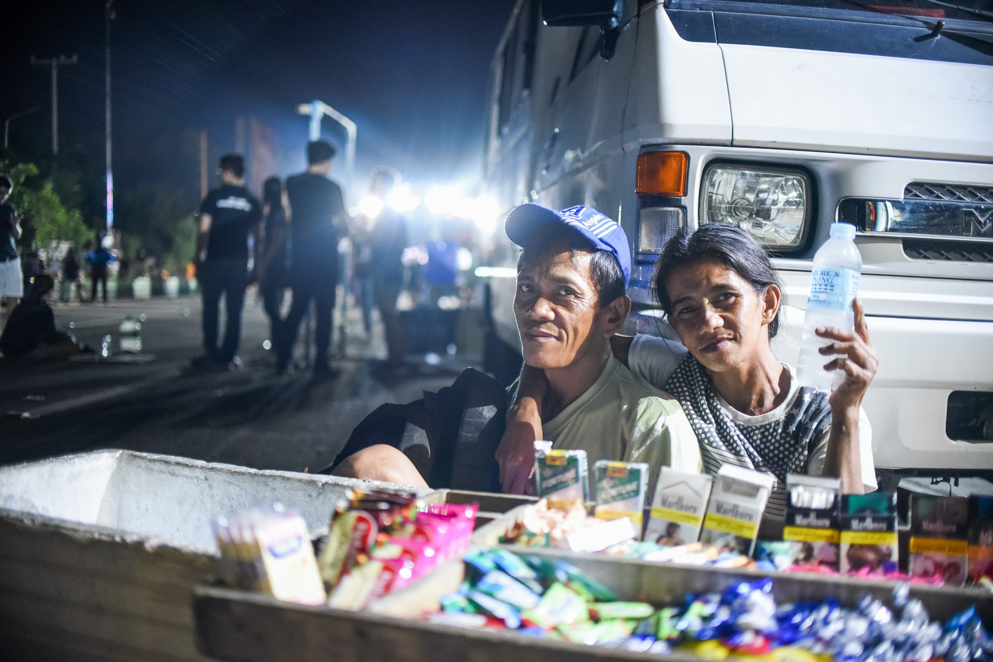 THE ANTONIOS. Danilo and Ging pick a spot beside a parked van at the People Power Monument to sell water, crackers, candies, and cigarettes. Photo by Martin San Diego/Rappler 